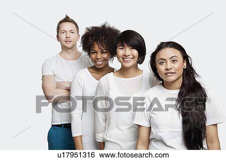 Stock Photograph - Portrait of multi-ethnic friends in casuals smiling together over white background. Fotosearch