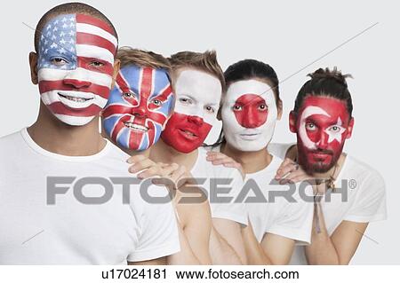 Stock Image - Portrait of Multi-ethnic group of male friends with various national flags painted on their faces standing against white background. Fotosearch