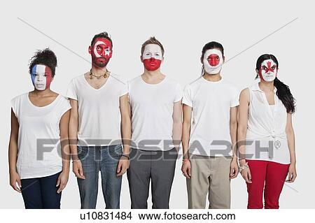 Portrait of Multi-ethnic group of friends with various national flags painted on their faces standing at attention against white background View Large Photo Image Picture - Portrait of Multi-ethnic group of friends with various national flags painted on their faces standing at attention against white background. Fotosearch
