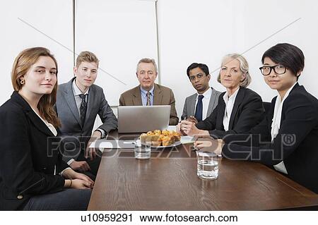 Stock Image - Portrait of multiethnic professionals in meeting at conference room. Fotosearch