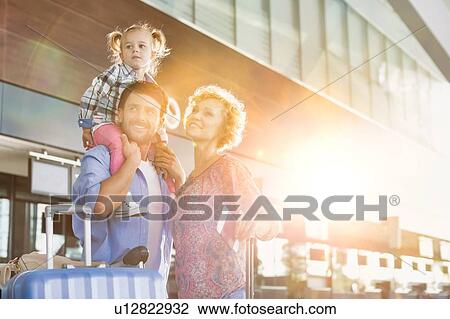 Portrait of one happy family arriving in airport with lens flare View Large Photo Image Stock Image - Portrait of one happy family arriving in airport with lens flare. Fotosearch