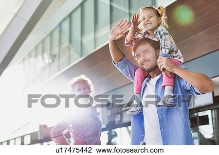 Portrait of one happy family arriving in airport with lens flare View Large Photo Image Stock Image - Portrait of one happy family arriving in airport with lens flare. Fotosearch
