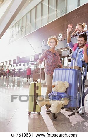 Portrait of one happy family arriving in airport with lens flare View Large Photo Image Stock Image - Portrait of one happy family arriving in airport with lens flare. Fotosearch
