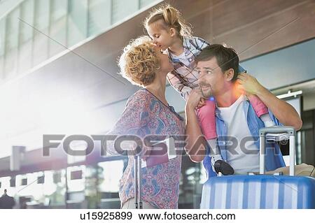 Portrait of one happy family arriving in airport with lens flare View Large Photo Image Stock Photo - Portrait of one happy family arriving in airport with lens flare. Fotosearch