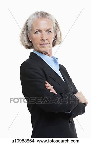Picture - Portrait of senior woman businesswoman with arms crossed against white background. Fotosearch