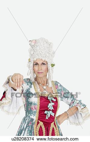 Picture - Portrait of serious senior queen gesturing over gray background. Fotosearch
