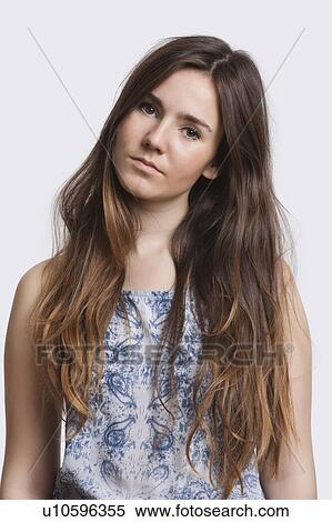 Portrait of serious young woman over white background View Large Photo Image Stock Photography - Portrait of serious young woman over white background. Fotosearch