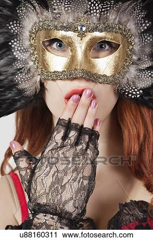 Portrait of shocked young woman with feathered eye mask View Large Photo Image Stock Image - Portrait of shocked young woman with feathered eye mask. Fotosearch