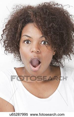 Portrait of shocked young woman with mouth open against white background View Large Photo Image Stock Photography - Portrait of shocked young woman with mouth open against white background. Fotosearch