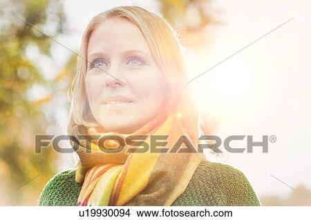 Portrait of Smiling beautiful mature woman in park View Large Photo Image Picture - Portrait of Smiling beautiful mature woman in park. Fotosearch