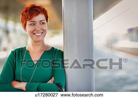 Portrait of smiling confident businesswoman standing with arms crossed View Large Photo Image Stock Photo - Portrait of smiling confident businesswoman standing with arms crossed. Fotosearch