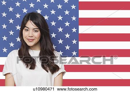 Portrait of smiling mixed race young woman against American flag View Large Photo Image Stock Image - Portrait of smiling mixed race young woman against American flag. Fotosearch