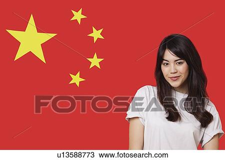 Portrait of smiling mixed race young woman against Chinese flag View Large Photo Image Stock Image - Portrait of smiling mixed race young woman against Chinese flag. Fotosearch