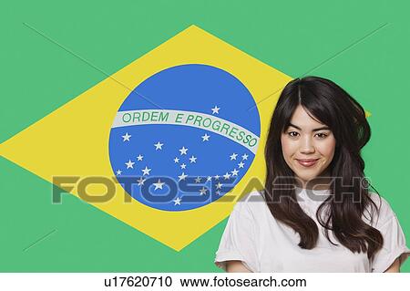 Portrait of smiling mixed race young woman against Brazilian flag View Large Photo Image Stock Image - Portrait of smiling mixed race young woman against Brazilian flag. Fotosearch
