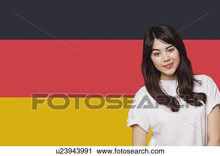 Portrait of smiling mixed race young woman against German flag View Large Photo Image Stock Image - Portrait of smiling mixed race young woman against German flag. Fotosearch