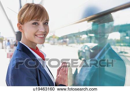 Portrait of smiling young attractive flight attendant in airport View Large Photo Image Stock Image - Portrait of smiling young attractive flight attendant in airport. Fotosearch