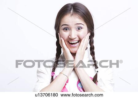 Portrait of surprised young woman with pigtails against white background View Large Photo Image Stock Image - Portrait of surprised young woman with pigtails against white background. Fotosearch