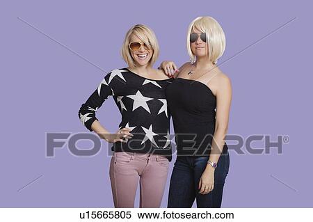 Portrait of two beautiful multi ethnic women smiling over purple background View Large Photo Image Stock Photography - Portrait of two beautiful multi ethnic women smiling over purple background. Fotosearch