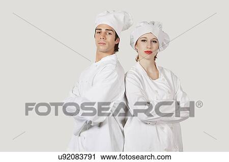 Portrait of two confident chefs with arms crossed against gray background View Large Photo Image Stock Image - Portrait of two confident chefs with arms crossed against gray background. Fotosearch