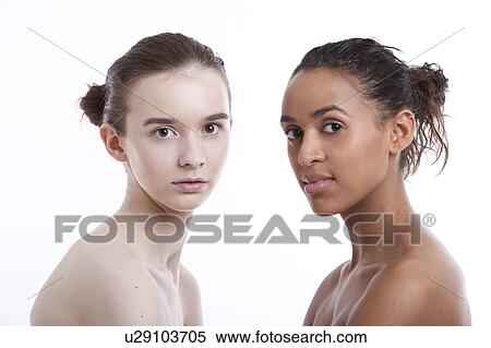 Stock Photography - Portrait of two shirtless young women against white background. Fotosearch