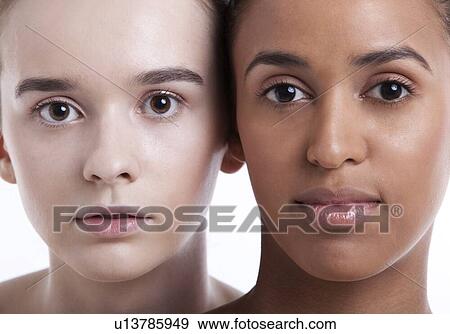Portrait of two young female friends against white background View Large Photo Image Stock Photo - Portrait of two young female friends against white background. Fotosearch
