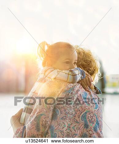 Portrait of woman reuniting with her daughter in airport View Large Photo Image Stock Image - Portrait of woman reuniting with her daughter in airport. Fotosearch