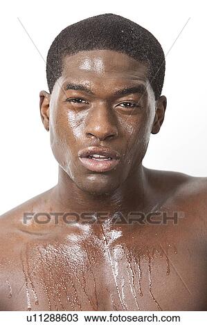 Portrait of young African American man sweating over white background View Large Photo Image Stock Image - Portrait of young African American man sweating over white background. Fotosearch