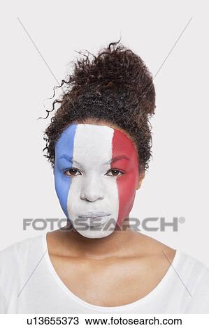 Portrait of young African American woman with French flag painted on face against white background View Large Photo Image Stock Image - Portrait of young African American woman with French flag painted on face against white background. Fotosearch