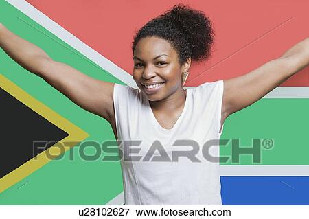 Stock Photo - Portrait of young African American woman smiling against South African flag. Fotosearch
