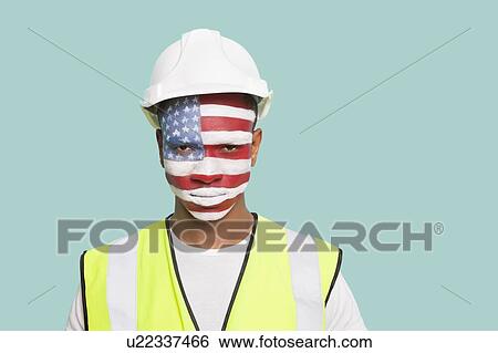 Portrait of young architect with American flag painted on face against colored background View Large Photo Image Stock Photograph - Portrait of young architect with American flag painted on face against colored background. Fotosearch