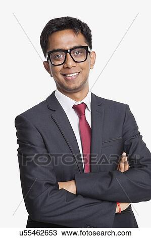 Portrait of young Asian businessman with arms crossed against white background View Large Photo Image Stock Image - Portrait of young Asian businessman with arms crossed against white background. Fotosearch