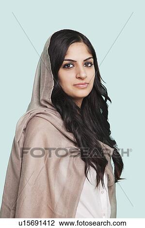 Portrait of young Asian woman in traditional clothing standing against blue background View Large Photo Image Stock Image - Portrait of young Asian woman in traditional clothing standing against blue background. Fotosearch