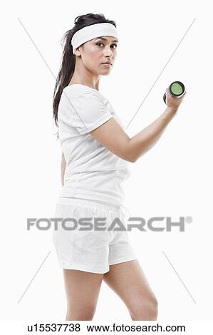 Portrait of young Asian woman raising dumbbell over white background View Large Photo Image Stock Photo - Portrait of young Asian woman raising dumbbell over white background. Fotosearch