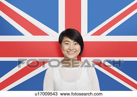 Portrait of young Asian woman smiling against British flag View Large Photo Image Stock Image - Portrait of young Asian woman smiling against British flag. Fotosearch