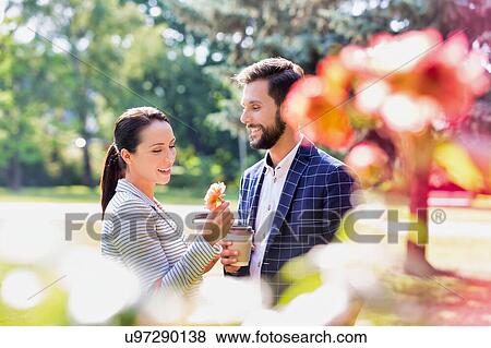 Portrait of young attractive business couple dating in park during break View Large Photo Image Stock Photo - Portrait of young attractive business couple dating in park during break. Fotosearch