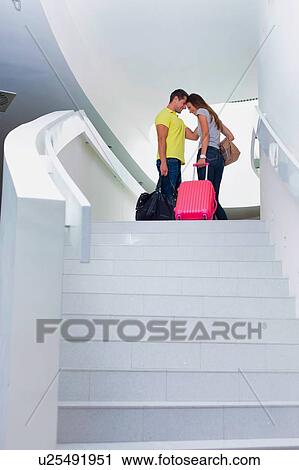 Stock Image - Portrait of young attractive couple standing and cuddling each other. Fotosearch
