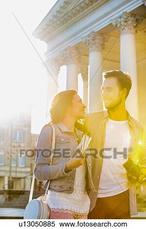 Portrait of young attractive couple standing against museum with lens flare in background View Large Photo Image Stock Photography - Portrait of young attractive couple standing against museum with lens flare in background. Fotosearch