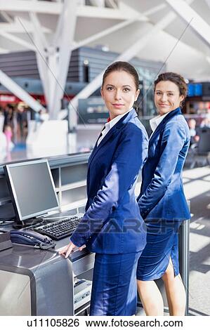 Portrait of young attractive passemger service agent standing in airport View Large Photo Image Stock Photograph - Portrait of young attractive passemger service agent standing in airport. Fotosearch