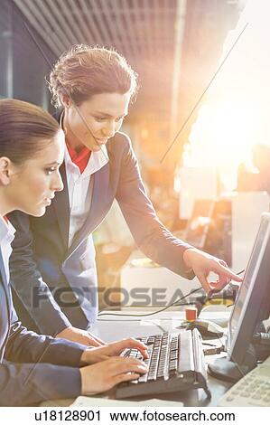Stock Image - Portrait of young attractive passenger service agents working in airport with lens flare. Fotosearch
