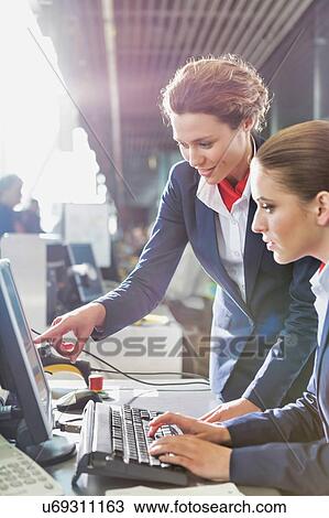 Portrait of young attractive passenger service agents working in airport with lens flare View Large Photo Image Stock Image - Portrait of young attractive passenger service agents working in airport with lens flare. Fotosearch