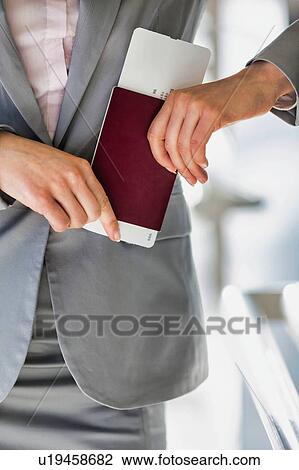Portrait of young attractive businesswoman holding her passport and boarding pass in airport View Large Photo Image Stock Image - Portrait of young attractive businesswoman holding her passport and boarding pass in airport. Fotosearch