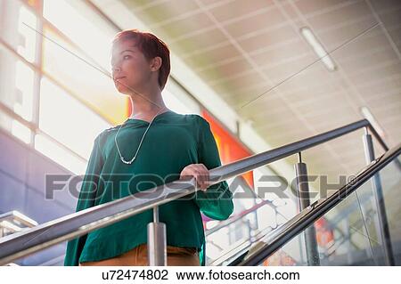 Portrait of young attractive businesswoman walking down stairs View Large Photo Image Stock Image - Portrait of young attractive businesswoman walking down stairs. Fotosearch