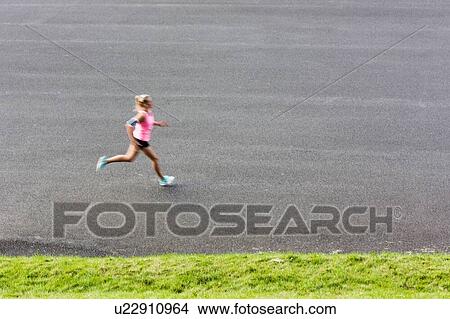 Picture - Portrait of young attractive woman running in park. Fotosearch