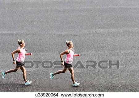 Picture - Portrait of young attractive woman running in park. Fotosearch