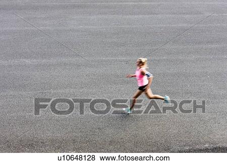 Portrait of young attractive woman running in park View Large Photo Image Stock Photo - Portrait of young attractive woman running in park. Fotosearch