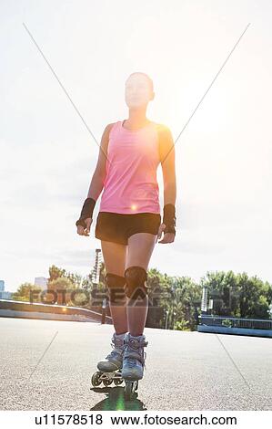 Portrait of young attractive woman wearing rollerblades View Large Photo Image Stock Photo - Portrait of young attractive woman wearing rollerblades. Fotosearch