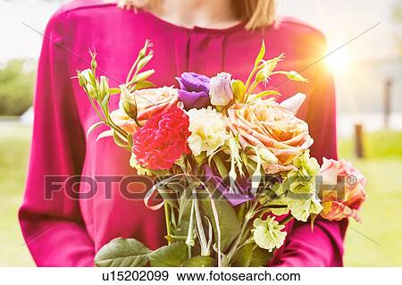 Portrait of young attractive woman holding boquet of flowers View Large Photo Image Stock Photo - Portrait of young attractive woman holding boquet of flowers. Fotosearch