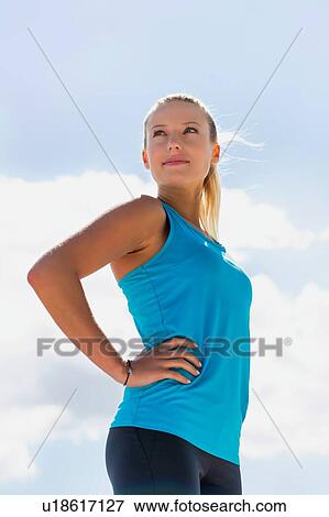 Portrait of young attractive woman exercising in park View Large Photo Image Stock Photo - Portrait of young attractive woman exercising in park. Fotosearch