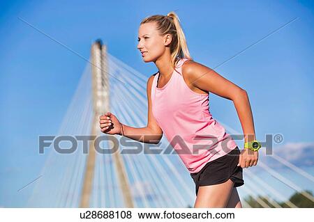 Portrait of young attractive woman running in park View Large Photo Image Stock Photo - Portrait of young attractive woman running in park. Fotosearch