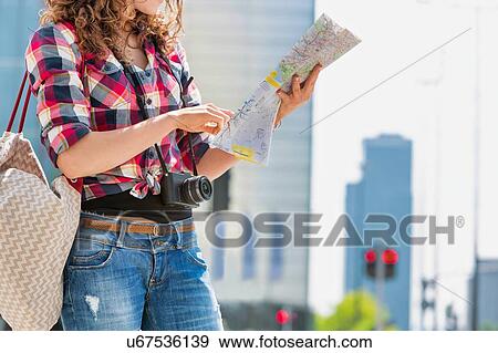 Portrait of young attractive woman looking on the map in the city View Large Photo Image Stock Photo - Portrait of young attractive woman looking on the map in the city. Fotosearch